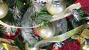 Top view of Christmas tree with shiny ornaments and blinking lights