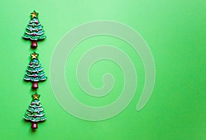 Top view Christmas trees on green background. Free copy space. Concept of decoration, greeting cards