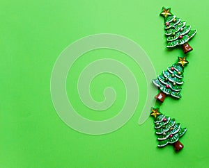 top view Christmas trees on green background. Free copy space. Concept of decoration, greeting cards