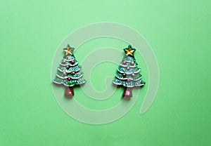 top view Christmas trees on green background. Free copy space. Concept of decoration, greeting cards