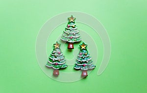 top view Christmas trees on green background. Free copy space. Concept of decoration, greeting cards