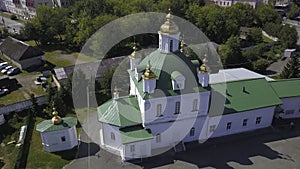 Top view of church with green roof. Clip. Beautiful white church with green roof and golden domes. Green Christian