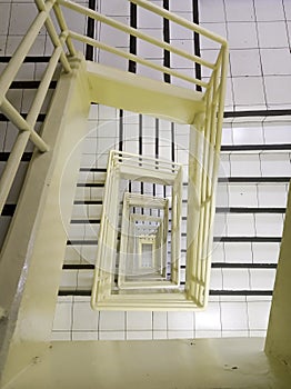 Top view of circular square white stair with hand rail