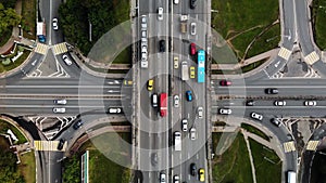 Top view of a city intersection with buses, cars, trucks. Traffic at daytime, roadcross in the megapolis. Going forward