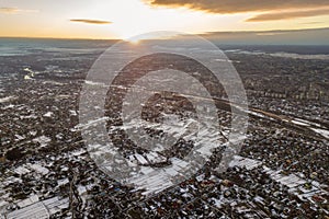 Top view of city suburbs or small town nice houses on winter morning on cloudy sky background. Aerial drone photography concept