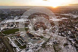 Top view of city suburbs or small town nice houses on winter morning on cloudy sky background. Aerial drone photography concept