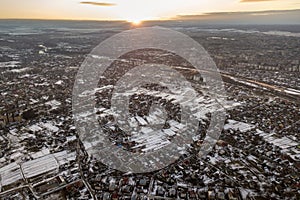 Top view of city suburbs or small town nice houses on winter morning on cloudy sky background. Aerial drone photography concept