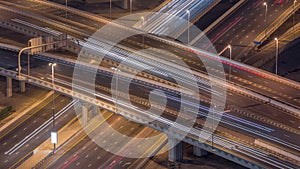 Top view city traffic on a big crossroad in Business bay night timelapse.