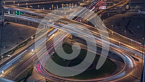 Top view city traffic on a big crossroad in Business bay night timelapse.