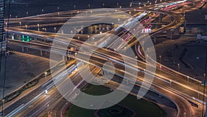 Top view city traffic on a big crossroad in Business bay night timelapse.