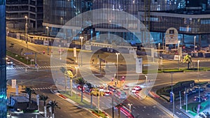 Top view city traffic on a crossroad in Dubai Business bay night timelapse.