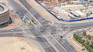 Top view city traffic on a crossroad in Dubai Downtown timelapse.