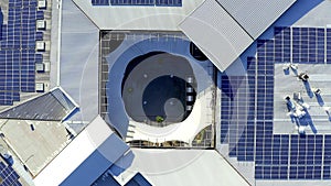 Top view, clean energy and solar power building with sustainability, natural and electricity. Drone, urban development
