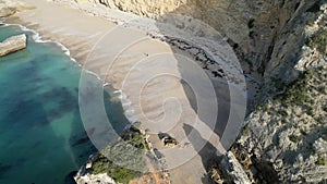 Top view of cliffs and rocks on an empty beach in Sesimbra, Portugal