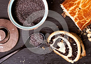 Top view close up image of poppy seed roll cake, traditional Christmas beigli on table on black background