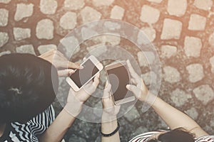 Top view.Close up of man and woman hands holding touching mobile phone with blank copy space for your text message on the road wit