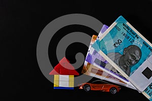 Top view close up shot of money, toy car and lego house in personal loan concept