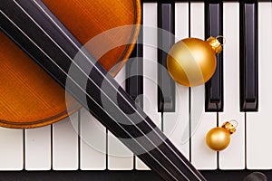 Top view close up shot of piano keyboard,old violin and Christmas decoration.