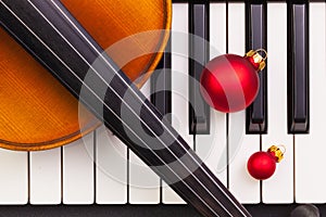 Top view close up shot of piano keyboard,old violin and Christmas decoration.