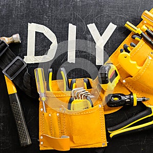 Top view close-up of tool belt with construction tools and word