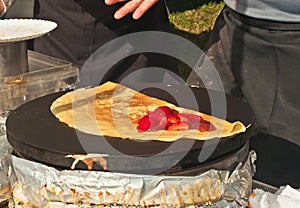 Top view of a vender preparing a strawberry crepe photo