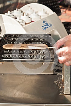 Top view of a vender preparing a waffle on a stick photo