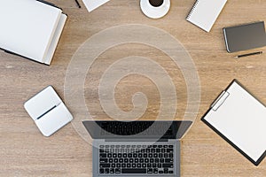 Top view and close up of wooden office desktop with supplies, devices and mock up place for your advertisement.