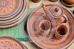 Top view closeup of beautiful Gujarati Khavda Pottery earthen terracotta crockery tea cups kettle and tray at a roadside market