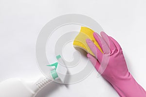 Top view closeup of cleaning gloves, sponge, and spray bottle on a white background