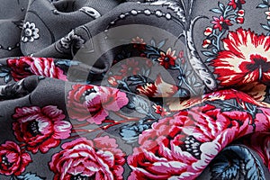 top view closeup on crumpled dark grey cotton scarf with pink floral ornament