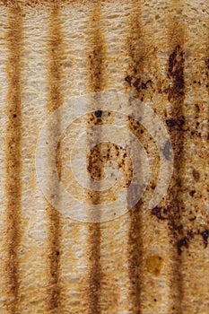 Top view close up macro detail of blank brown toasted bread slice texture background