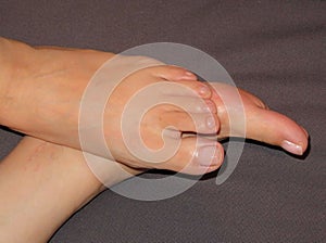 Top view closeup photo of woman feet relaxing on couch at home