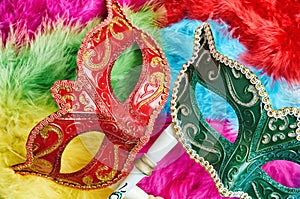 Top view, Closeup red and green venetian masquerade, Carnival mask, opera mask on colorful fluffy