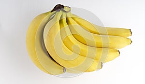 Top view and closeup of ripe yellow bunch of banans on the white background
