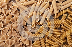 Top view  closeup of whole wheat farfalle  penne and fusilli pasta