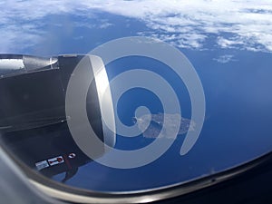 The top view of clouds and sky from an airplane window