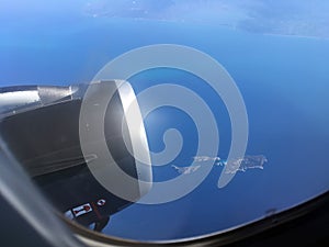 The top view of clouds and sky from an airplane window