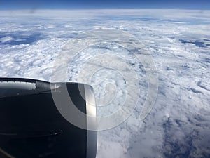The top view of clouds and sky from an airplane window