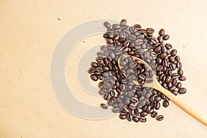 Top view of coffee beans on wooden spoon