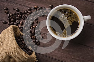 Top view /Coffee cup and coffee beans on wooden table