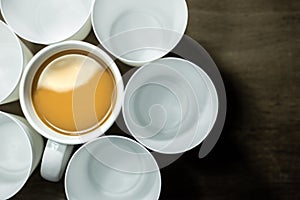 Top view of coffee cup and empty white glasses
