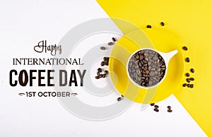 Top view of coffee cup full of beans on yellow and white background