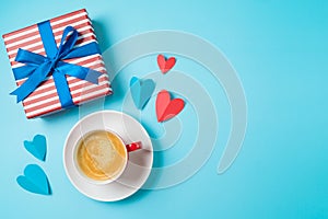 Top view of coffee cup, gift box and heart shapes on blue background. Happy Fathers day greeting card