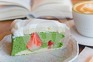 Top view of coffee cup and green tea cake , smart phone , book ,