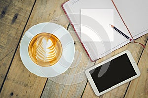 Top view of coffee cup with notebook and smart phone