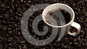 Top view of coffee or espresso with piles of coffee beans. Close up. Comestible.