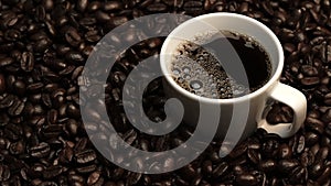 Top view of coffee or espresso with piles of coffee beans. Close up. Comestible. photo