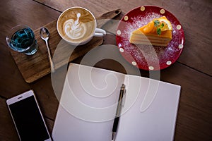 Top view coffee latte aroma cup and tasty christmas cake relaxtime waiting for idea on paper note on wood table in cafe coffee sh