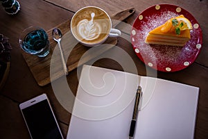 Top view coffee latte aroma cup and tasty christmas cake relaxtime waiting for idea on paper note on wood table in cafe coffee sh