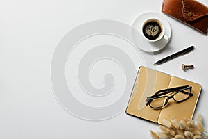 Top view of coffee, notepad with